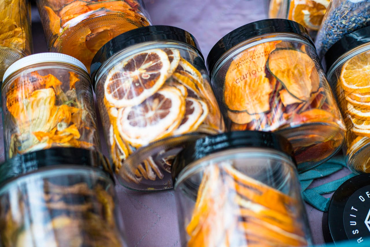 Glass jars filled with dried citrus and fruit slices